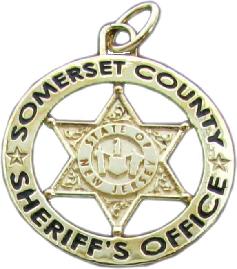 custom mini-badge jewelry pendant; round badge design of Somerset County Sheriff's Office; available in sterling silver, 10k or 14k yellow or white gold